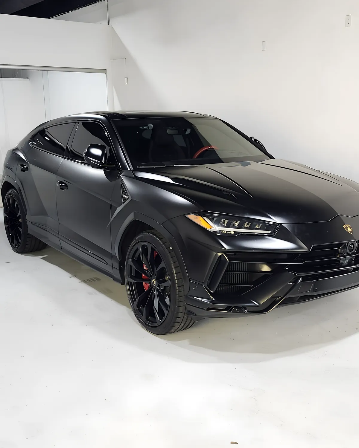 Black Lamborghini Urus in the white bay