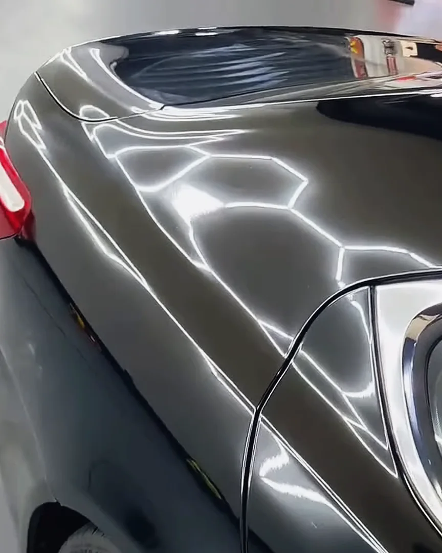 Black paint after a ceramic coating, hexagon lights reflected in it