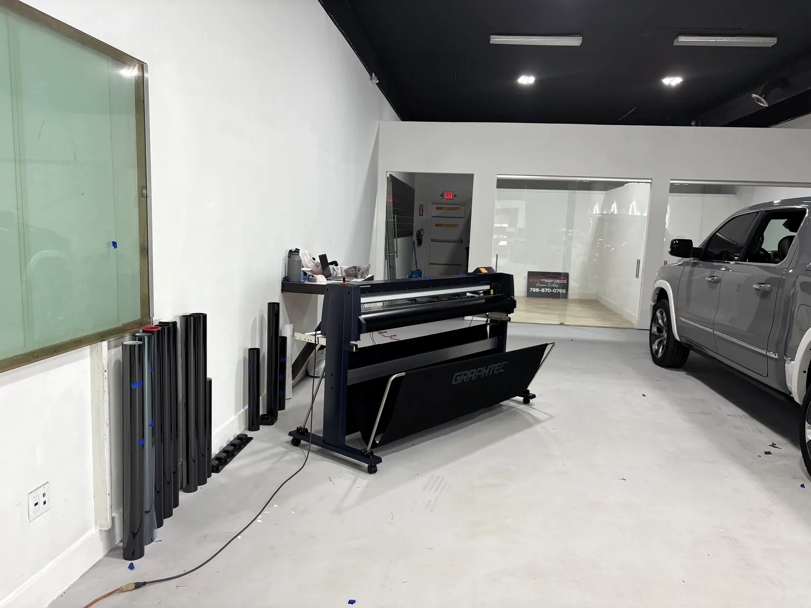 Vinyl plotter and film rolls in the bay