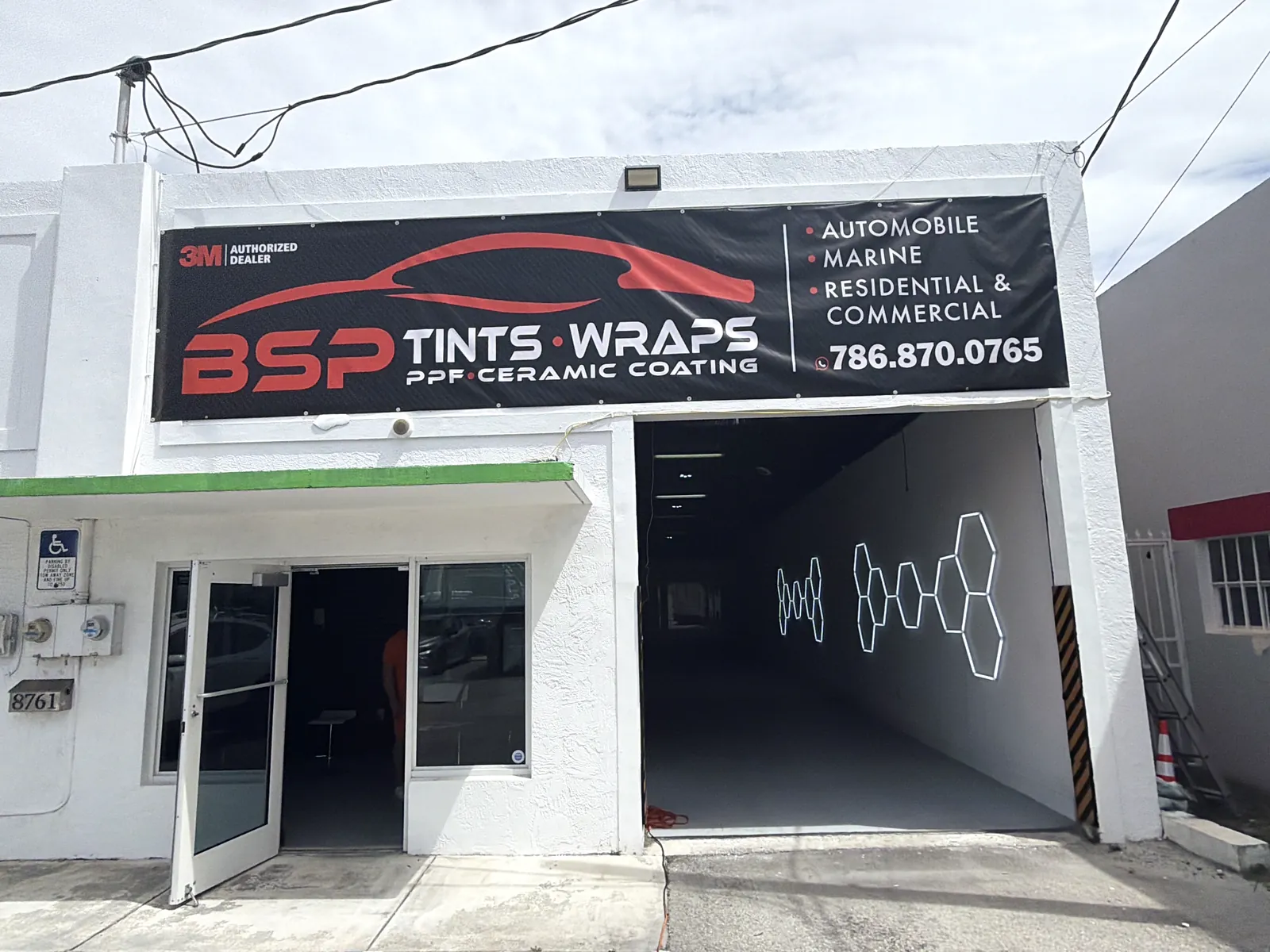The BSP Tints & Wraps sign over the open bay door on SW 132nd St