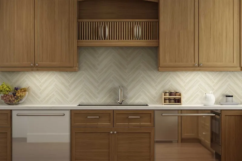 A cream herringbone marble-look backsplash across a wood-cabinet kitchen with a white quartz counter