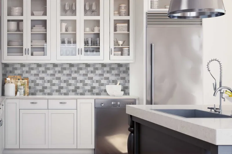 A white shaker kitchen with a grey marble-look brick mosaic backsplash