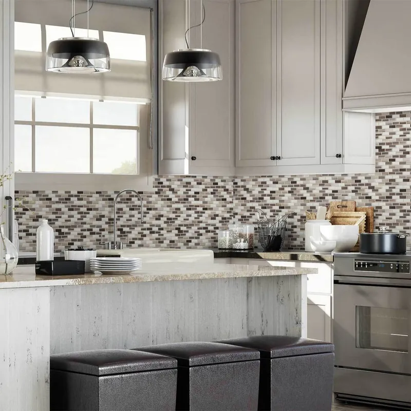 A kitchen with a neutral linear mosaic backsplash under a window