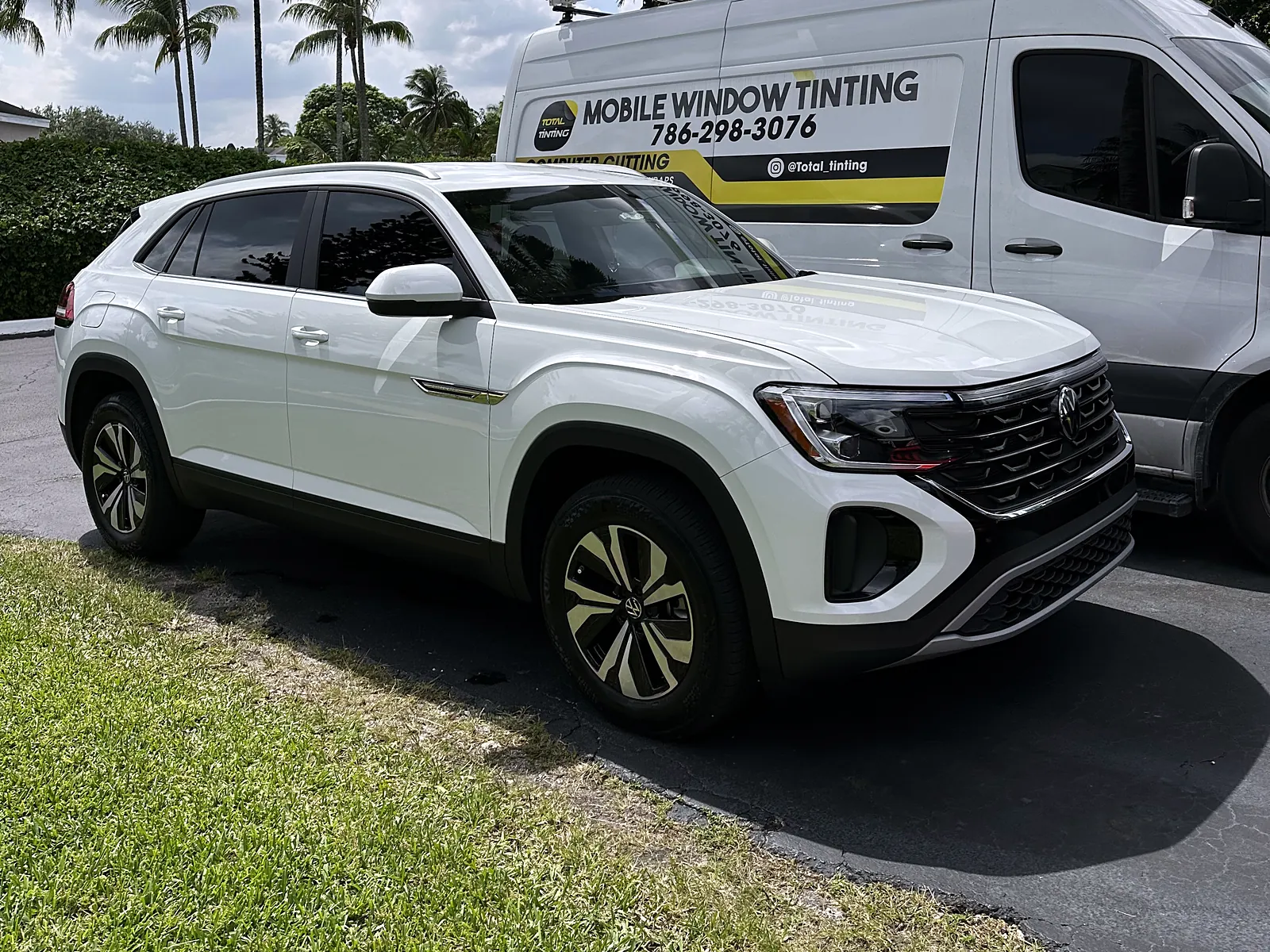 VW Atlas Cross Sport with fresh tint beside the lettered Total Tinting mobile van